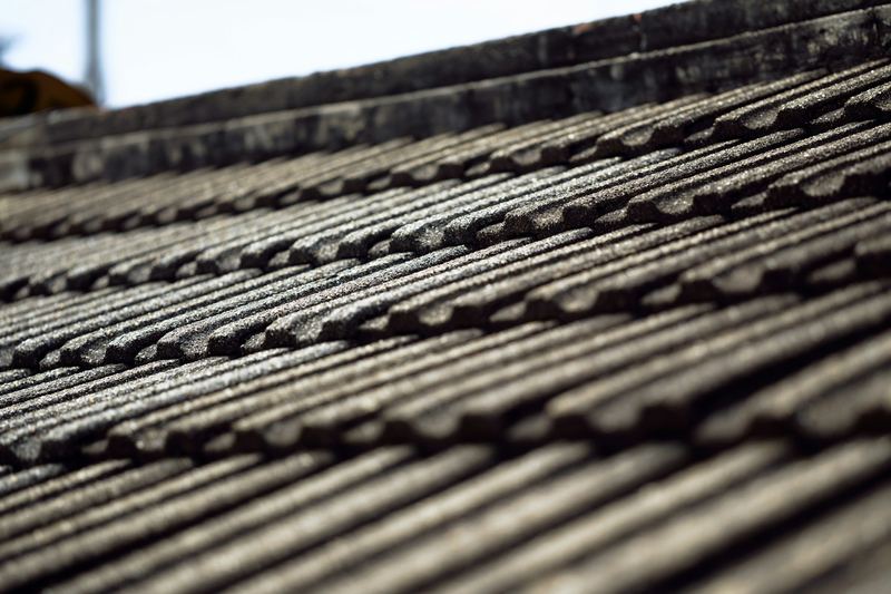 Close view of weathered grey concrete roof tiles